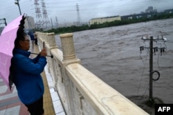 Extreme Rain in Beijing After Typhoon Turns Roads Into Rivers, Kills Two 