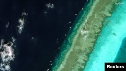 Satellite Images Reveal Floating Barrier at Mouth of Disputed Atoll in South China Sea 