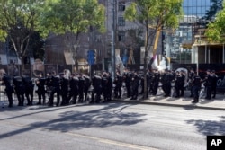 While police protect them, pride marchers demand better rights in Serbia